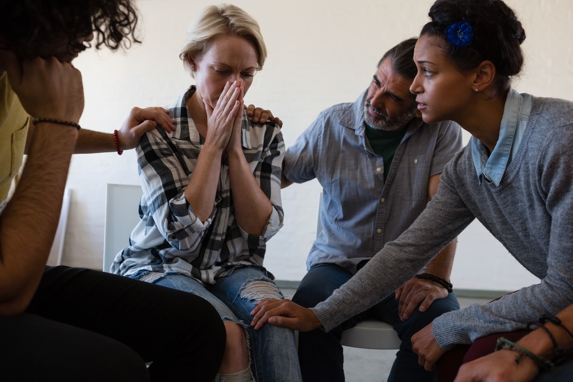 Friends consoling worried female