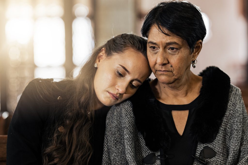 Sad, empathy and funeral with women in church for mourning, grief and death. Loss, respect and cons